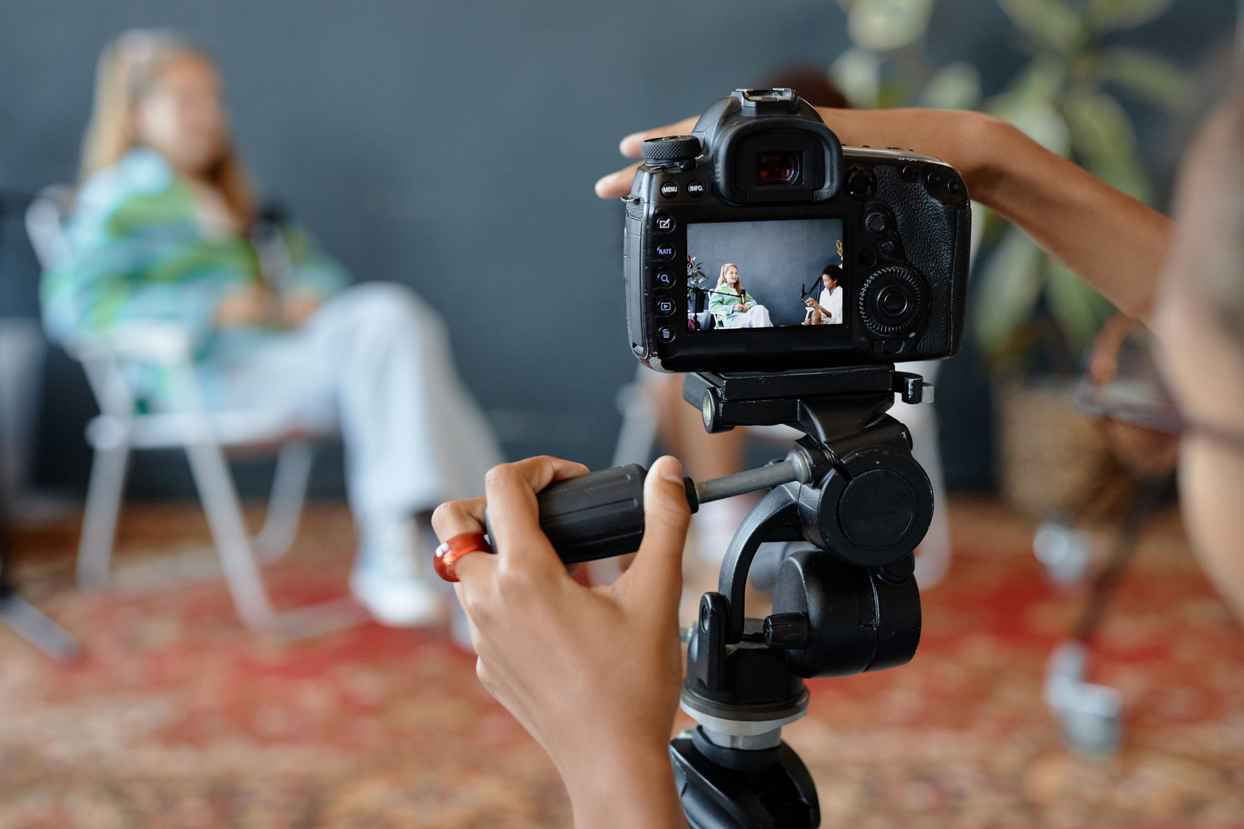 Close,Up,Of,Teenage,Kid,Setting,Up,Camera,On,Tripod