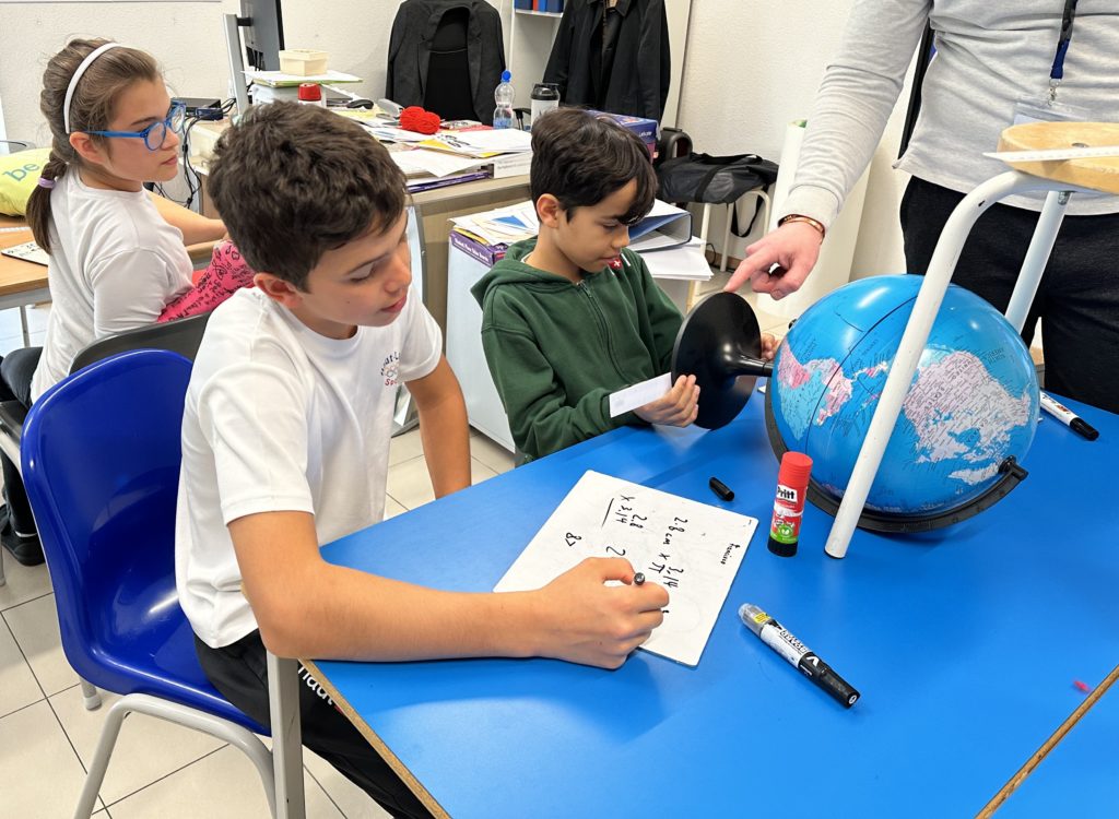 Haut-Lac primary school maths lesson - students learning about Pi